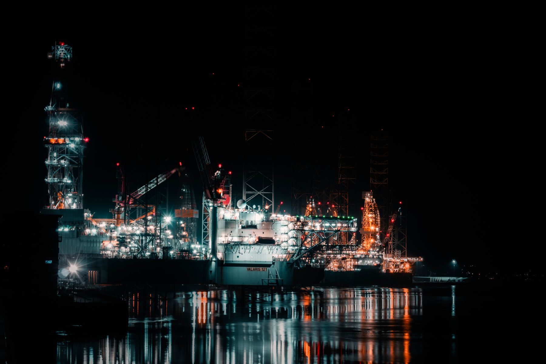 Offshore drilling platforms illuminated at night